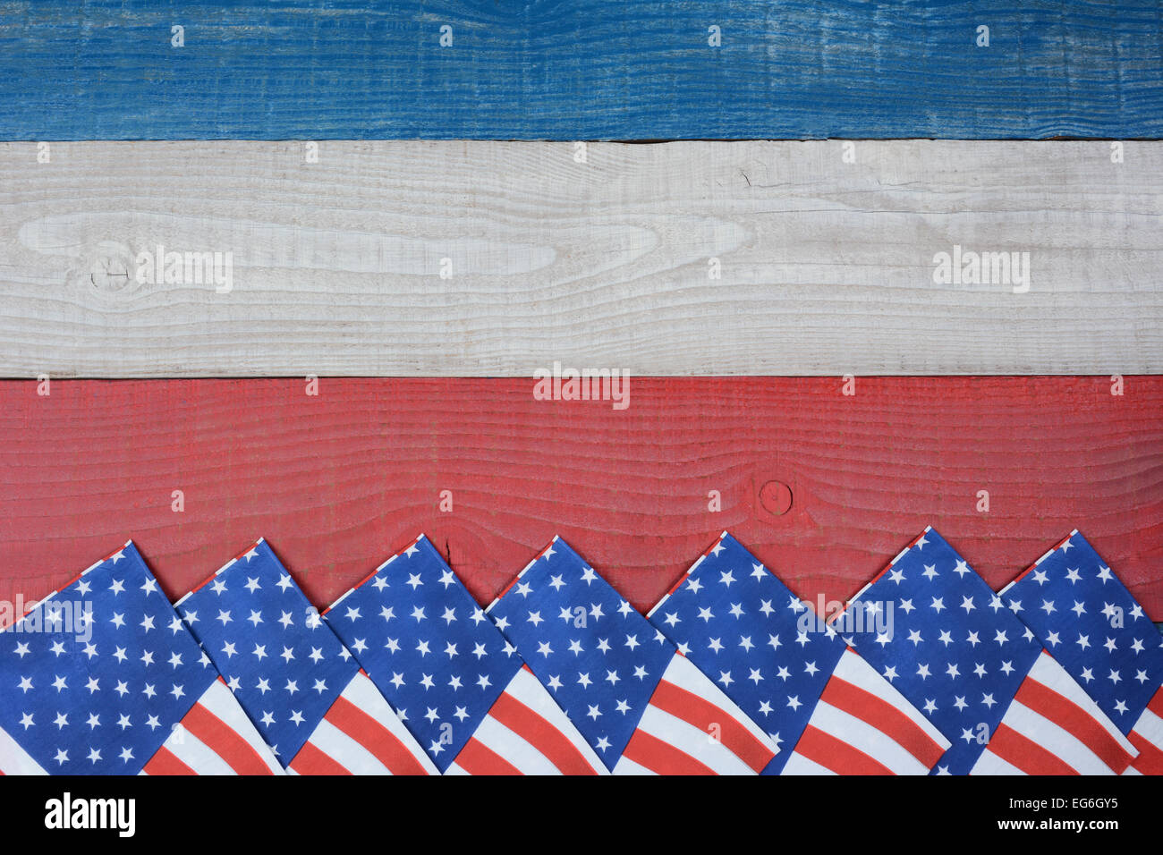 High angle shot of American Flag napkins spread out on a red, white and blue picnic table. Horizontal format with copy space. Su Stock Photo