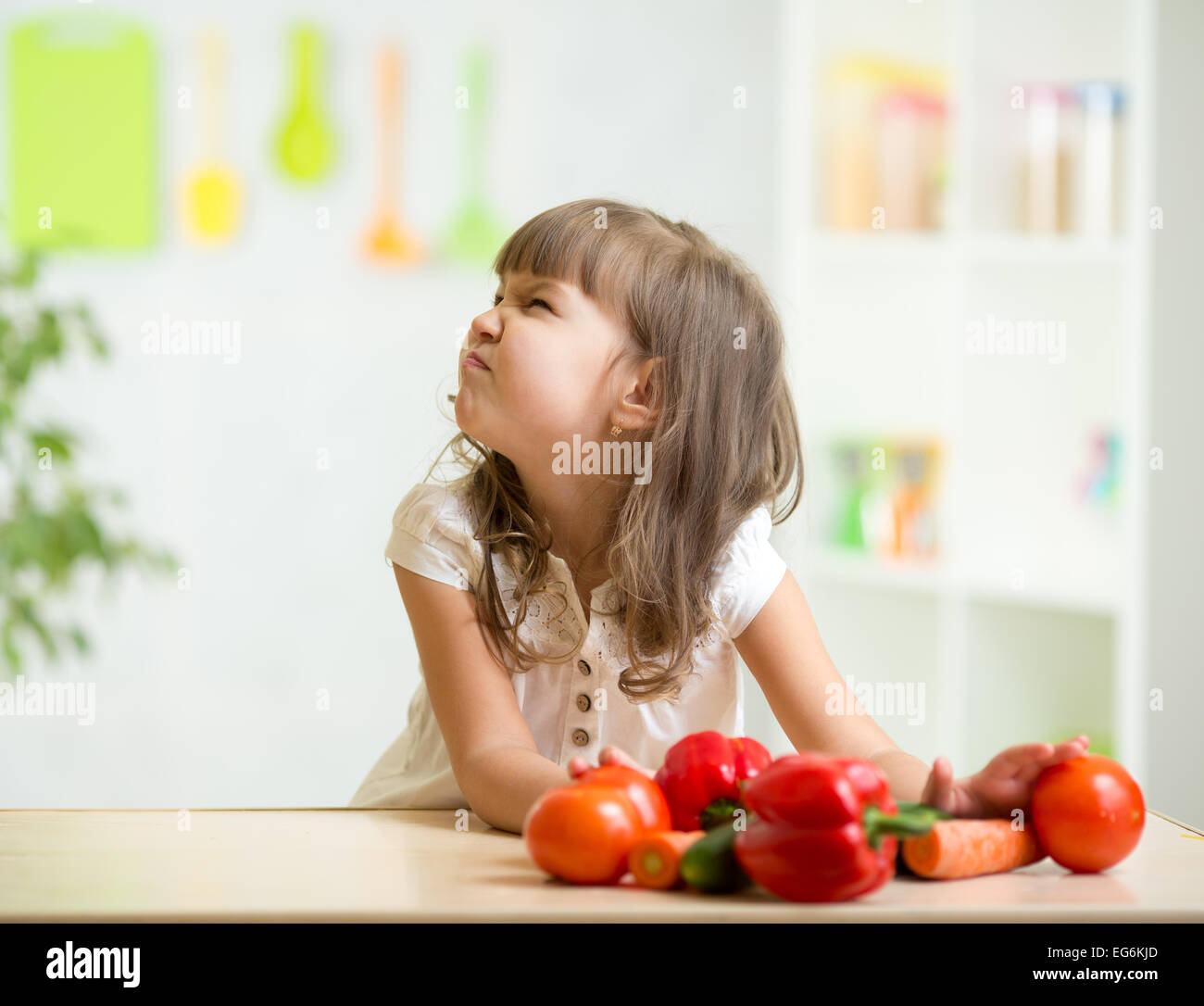 Kid girl with expression of disgust against vegetables stock photo alamy