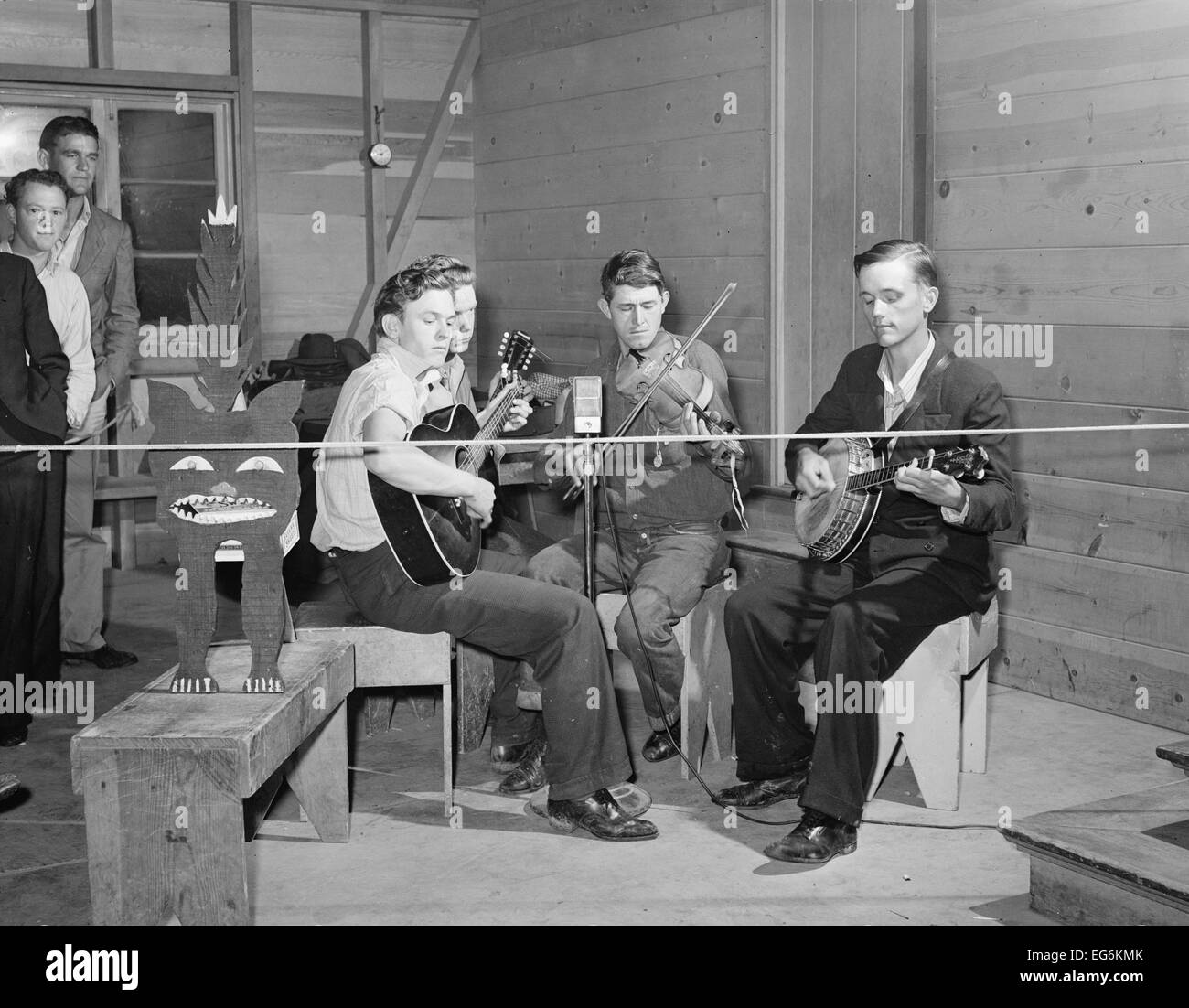 String band playing at Saturday night dance with a kitty for contributions,  Tulare migrant camp. Visalia, California, March 1940. Stock Photo