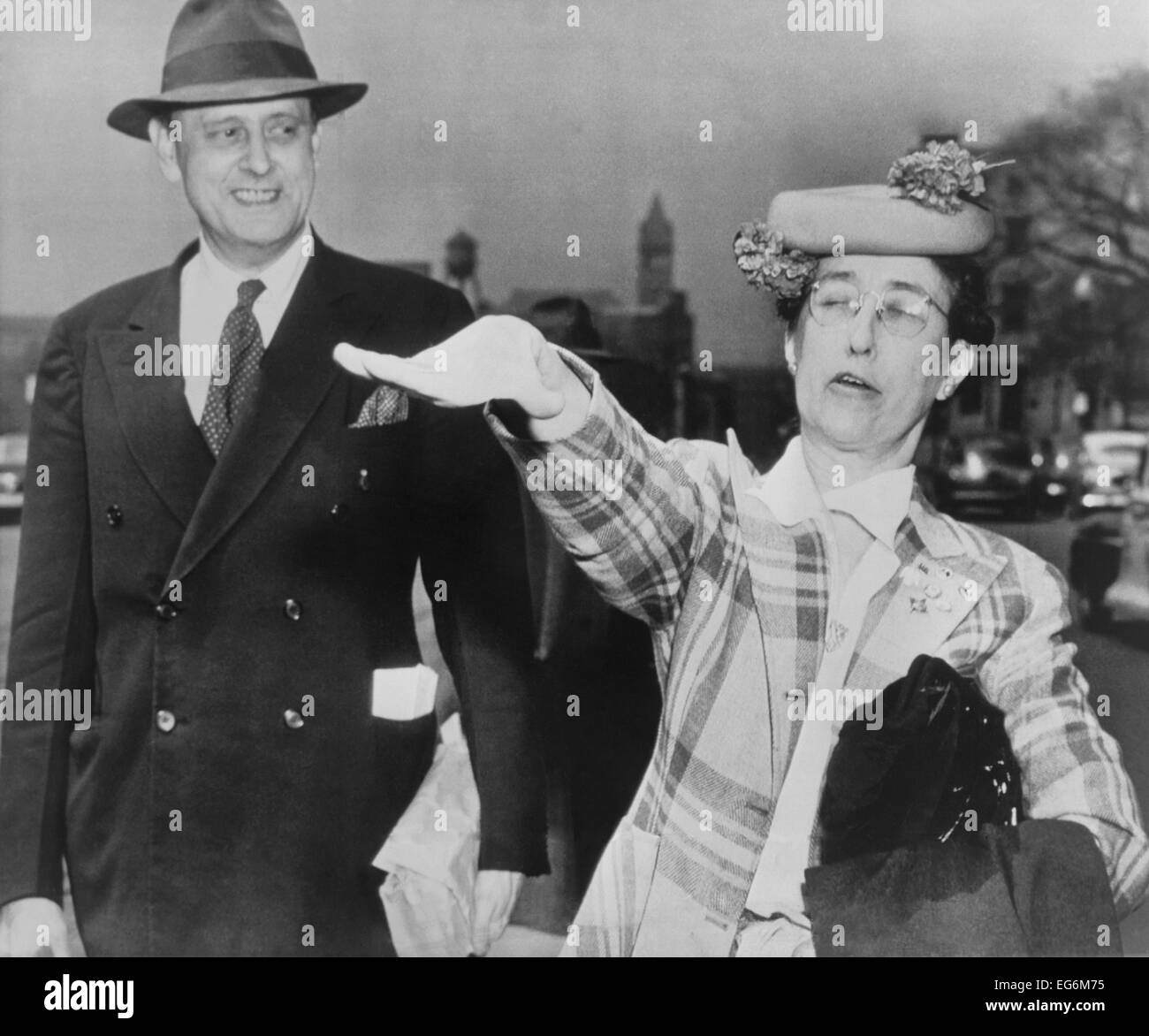 Lois de Lafayette Washburn gives a stiff-armed salute. She and Howard Victor Broenstrupp leave Federal District Court April 17, Stock Photo