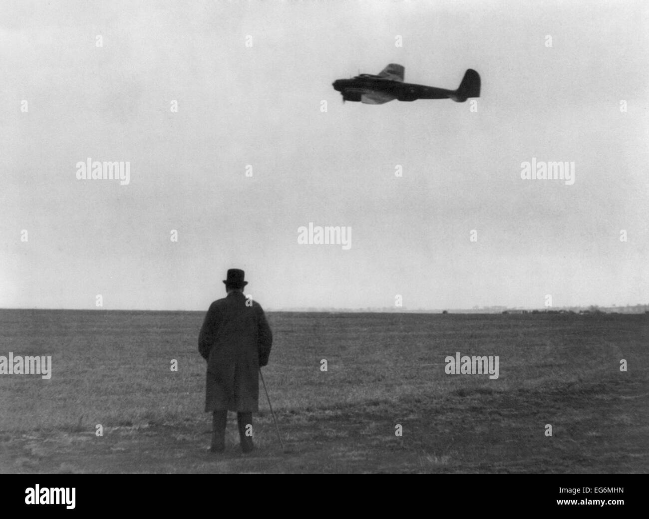 Winston Churchill, photographed from behind, watching B-17 'Flying Fortress' in flight. July 1940. World War 2. Stock Photo