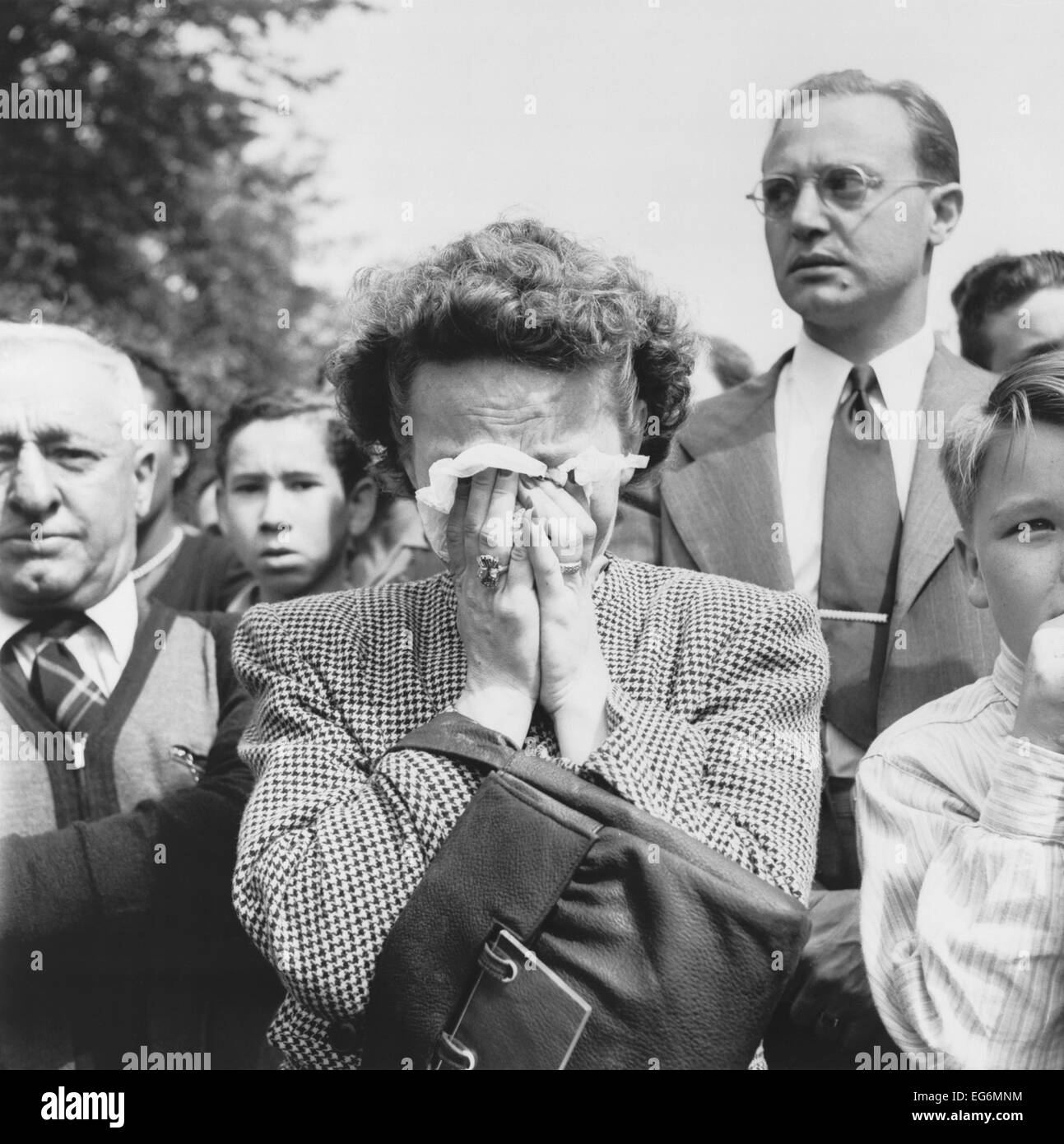 Woman weeps into her handkerchief at the funeral of President Franklin Roosevelt. Washington, D.C. April 14, 1945. World War 2. Stock Photo