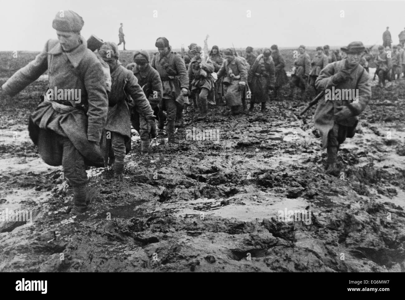 Soviet (Russian) soldiers marching through a muddy field near Odessa. Ca. 1944. World War 2 photograph by Georgi Zelma. Stock Photo
