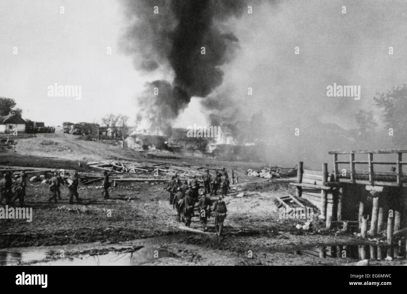 German infantry advancing on a burning village in the Soviet Union (Russia). Summer of 1941, during World War 2. Stock Photo