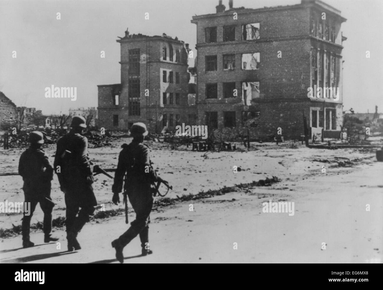 Three German soldiers walking in desolate street in the ruins of Stalingrad in Sept. 1942. The battle had begun on August 23, Stock Photo