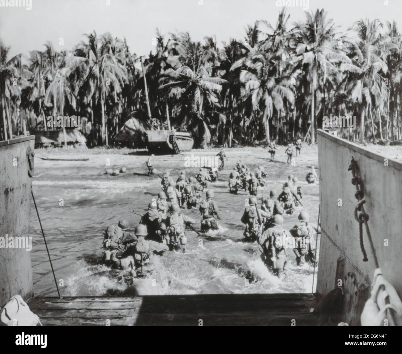 U.S. troops wade ashore, across heavily mined beaches, during invasion of Cebu Island. March 26, 1945. Philippines, World War Stock Photo