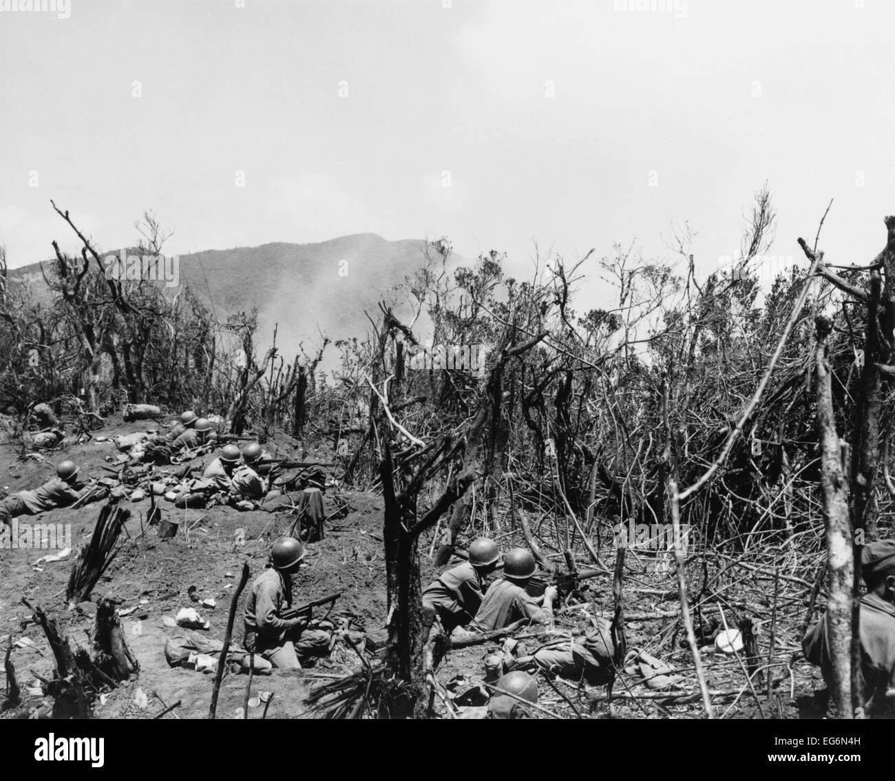 U.S. Troops dug in on Hill 604, Villa Verde Trail, fire on Japanese positions over the next ridge. April 1, 1945. Manila, Luzon Stock Photo