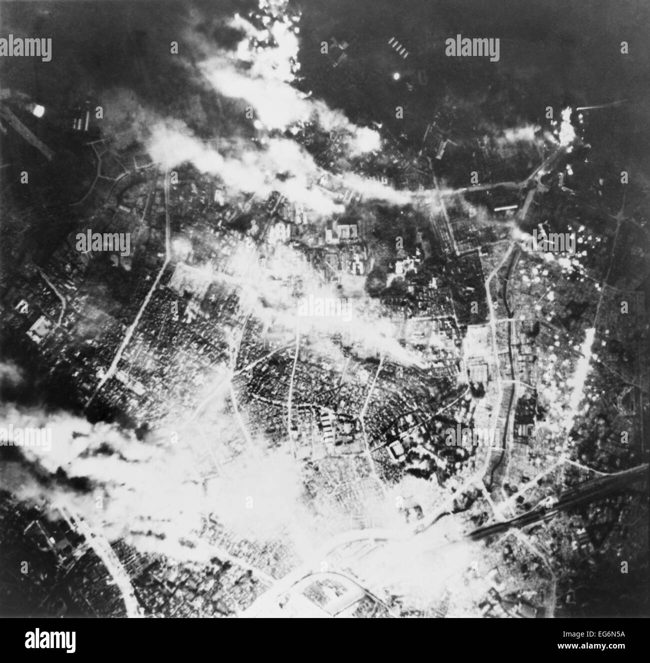Aerial view of Tokyo burning following incendiary bombing by B-29s, on the night of May 26, 1945. World War 2. Stock Photo