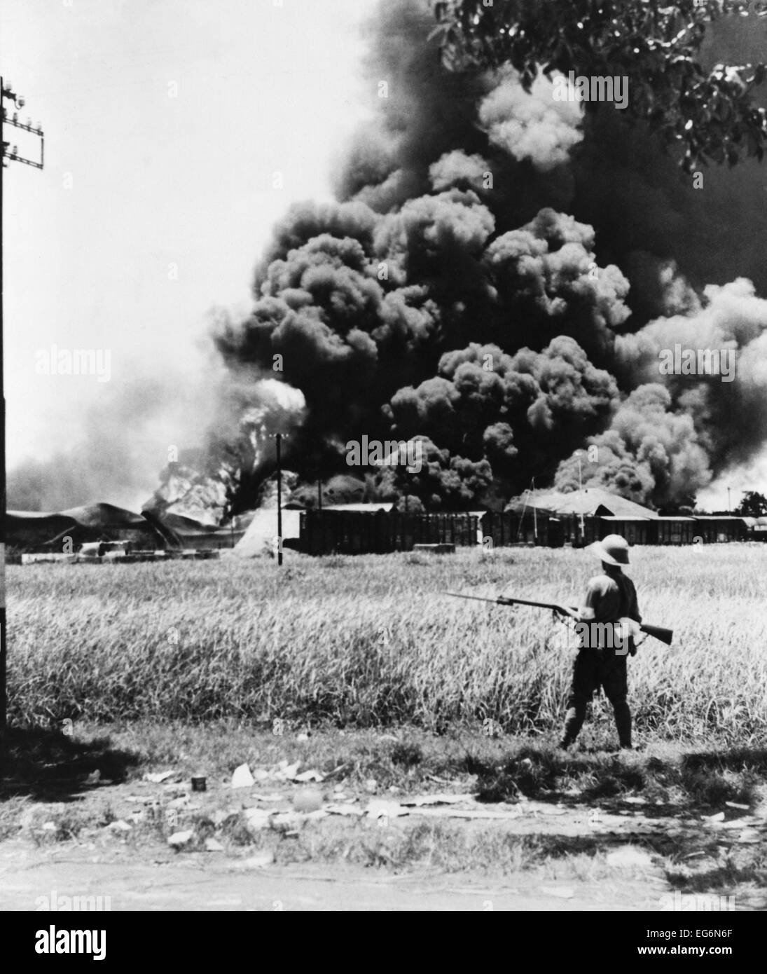 Burning oil tanks and cars left by retreating Dutch in Tandjong, Java. Ca. Feb.-Mar. 1942. World War 2. (BSLOC 2014 10 137) Stock Photo