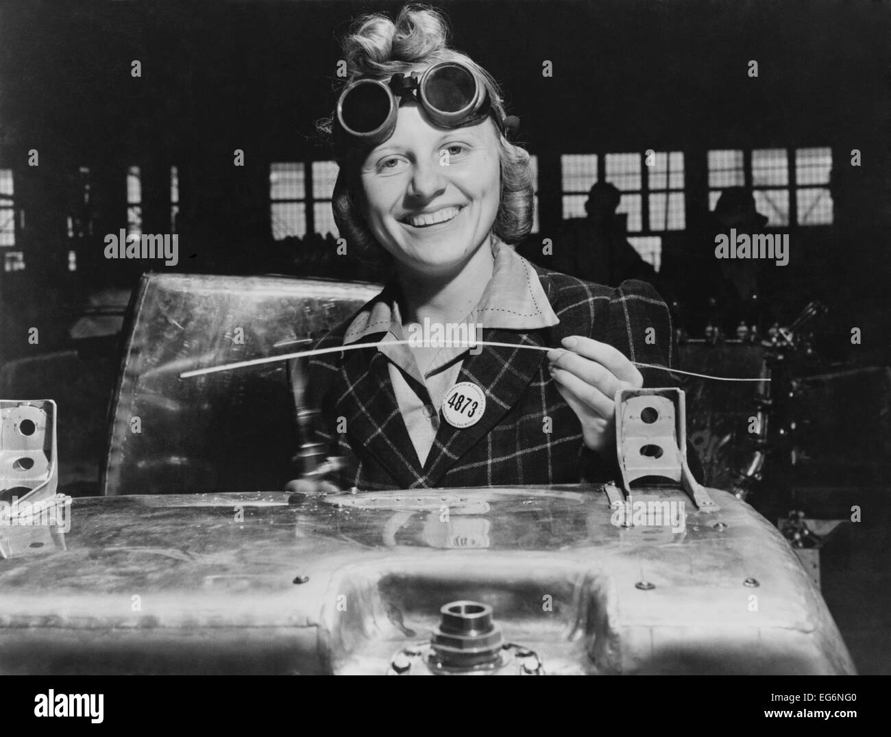 Woman welding a fuel tank for a Hawker Hurricane fighter airplane at