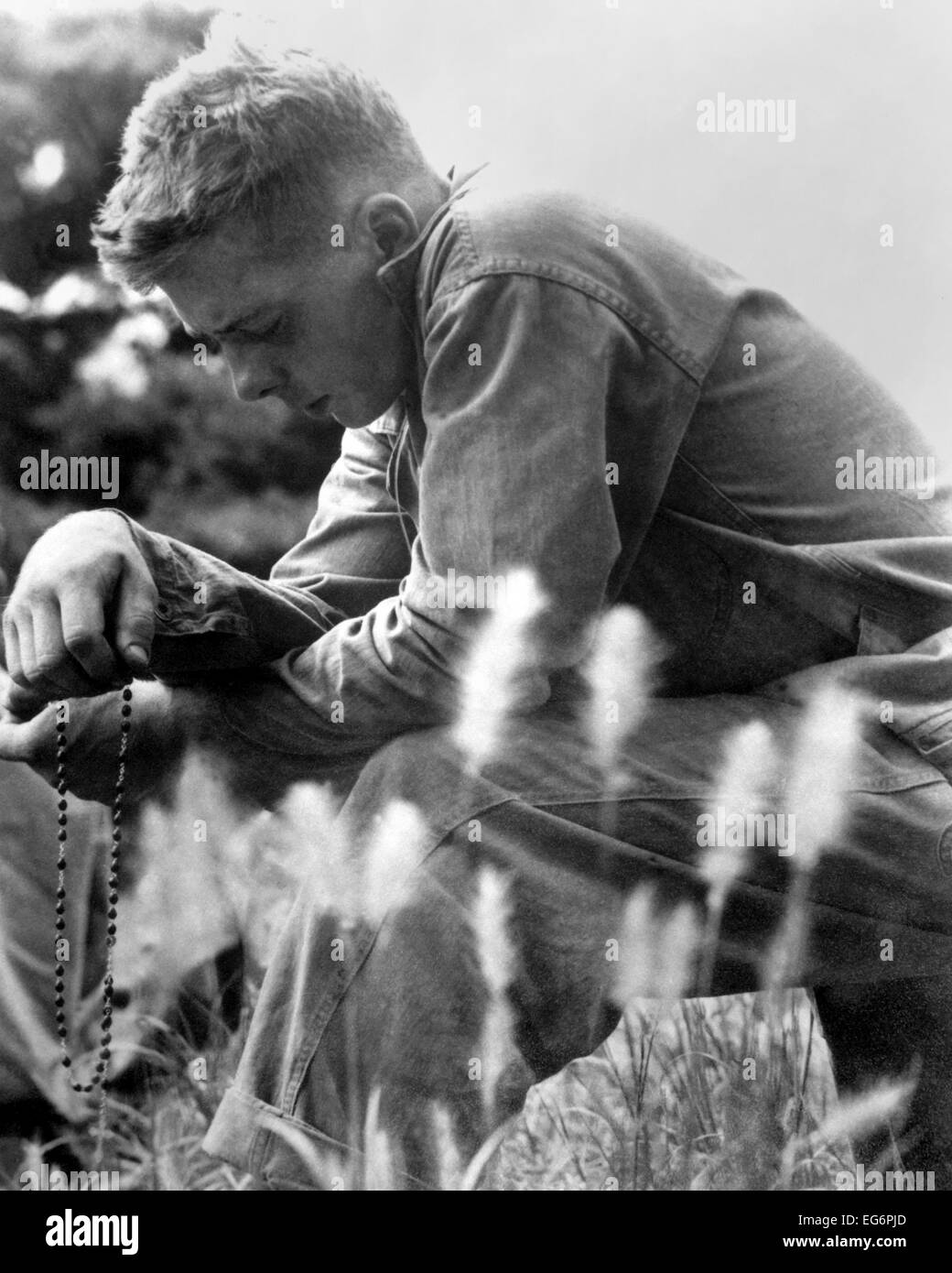 U.S. Marine in prayer for the safety of himself and his comrades. Minutes later, the 1st Marine Division launched an offensive Stock Photo