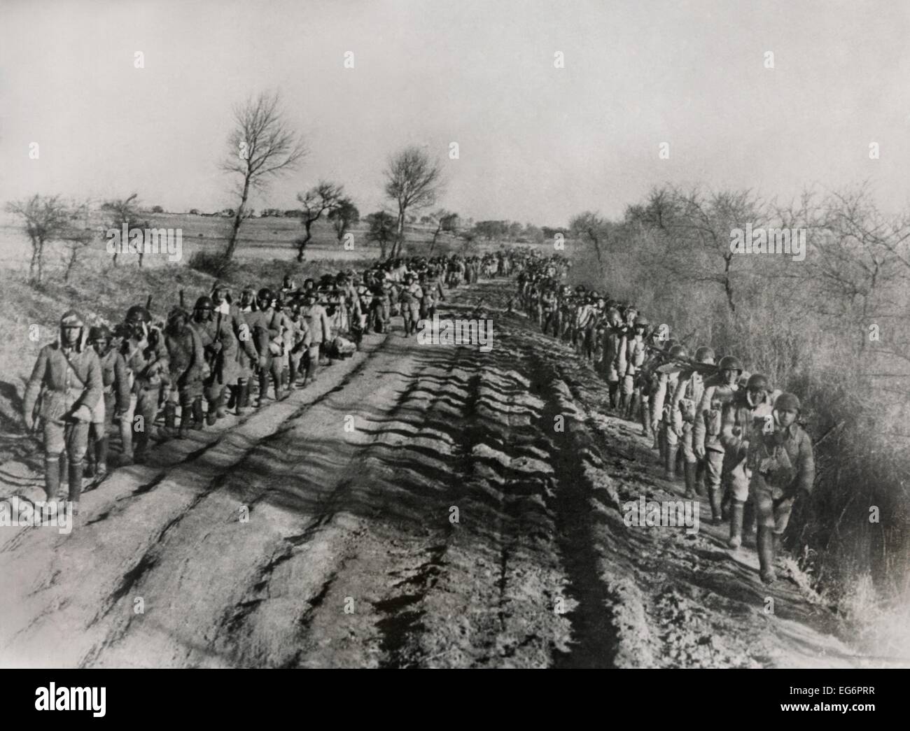 Chinese Civil War 1946-1949. Soldiers of the Chinese Nationalist Army march along a rutted road in Manchuria. Jan. 29, 1947. - Stock Photo