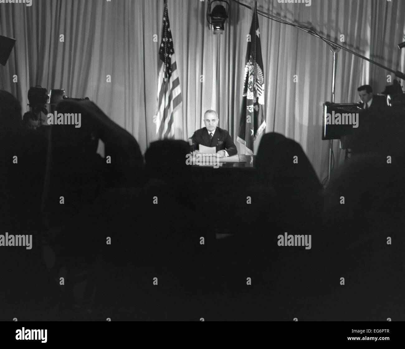 President Harry Truman seated at his desk with lights on and cameras rolling. He was announcing that World War 2 in Europe had Stock Photo