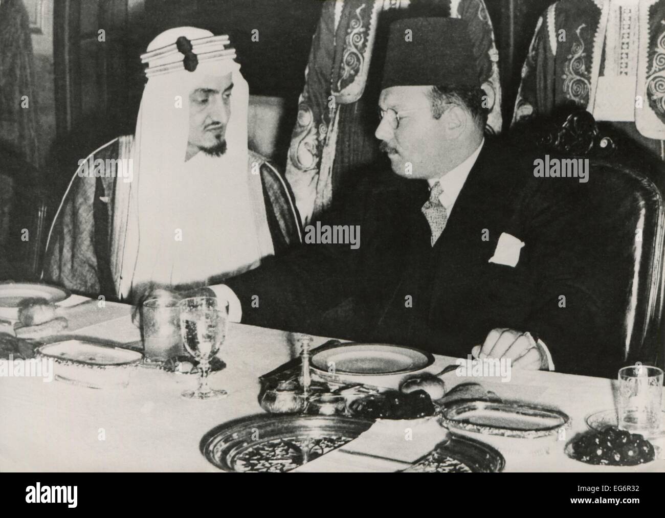 Prince Faisal l bin Abdulaziz of Saudi Arabia and King Farouk of Egypt. They dine at Ras el-Tin Palace in Alexandria following Stock Photo