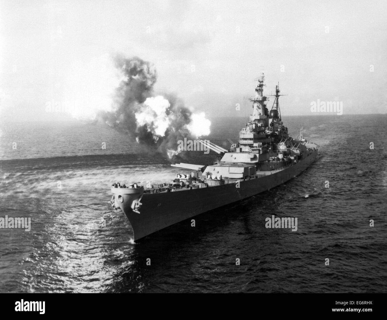 USS Missouri fires its 16-inch guns at Chong Jin, North Korea, Oct. 10, 1950. The attack intend to damage communications in the Stock Photo
