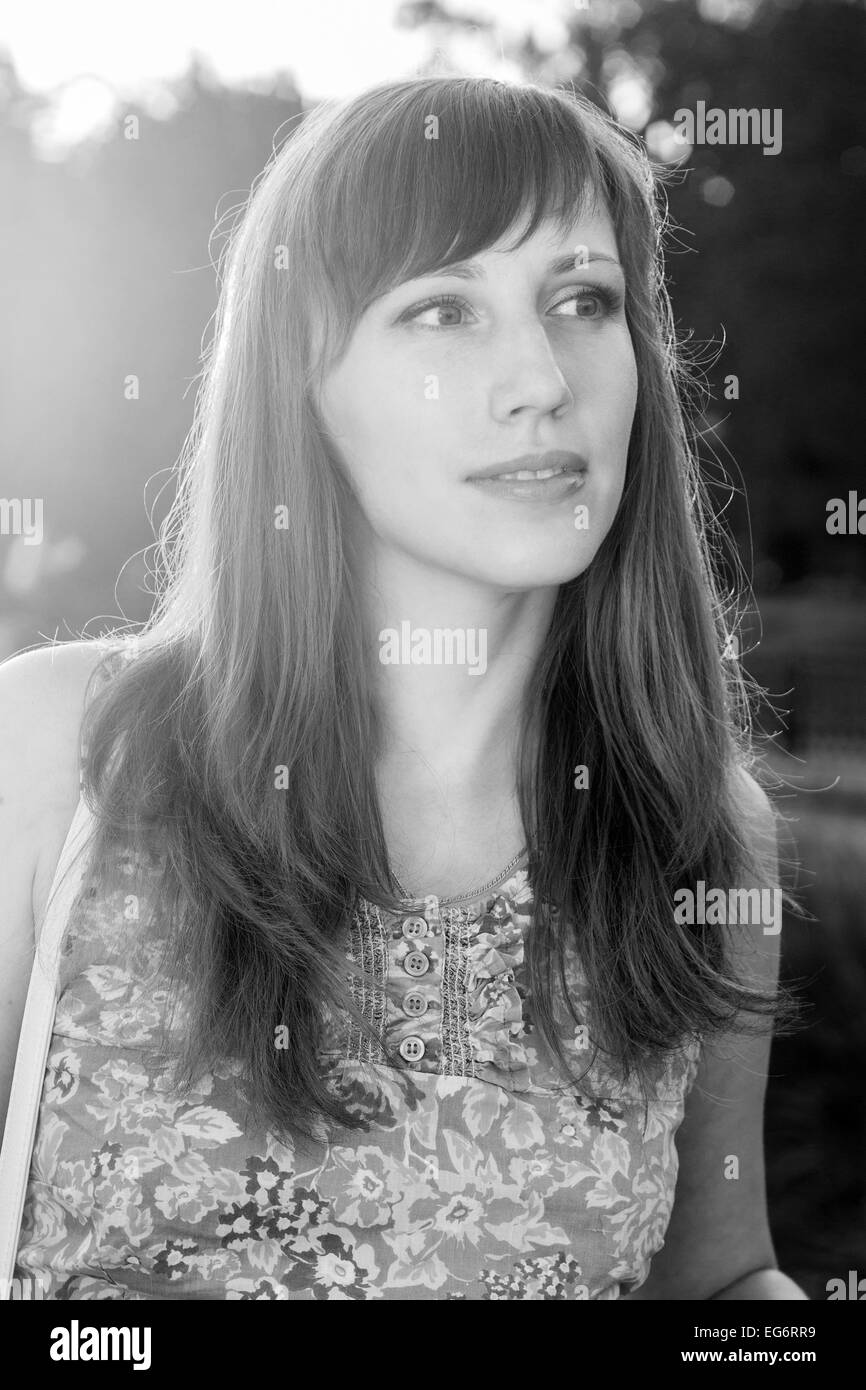 Young dreamy hipster girl posing at summer day. Pretty caucasian woman dreaming at sundown Stock Photo