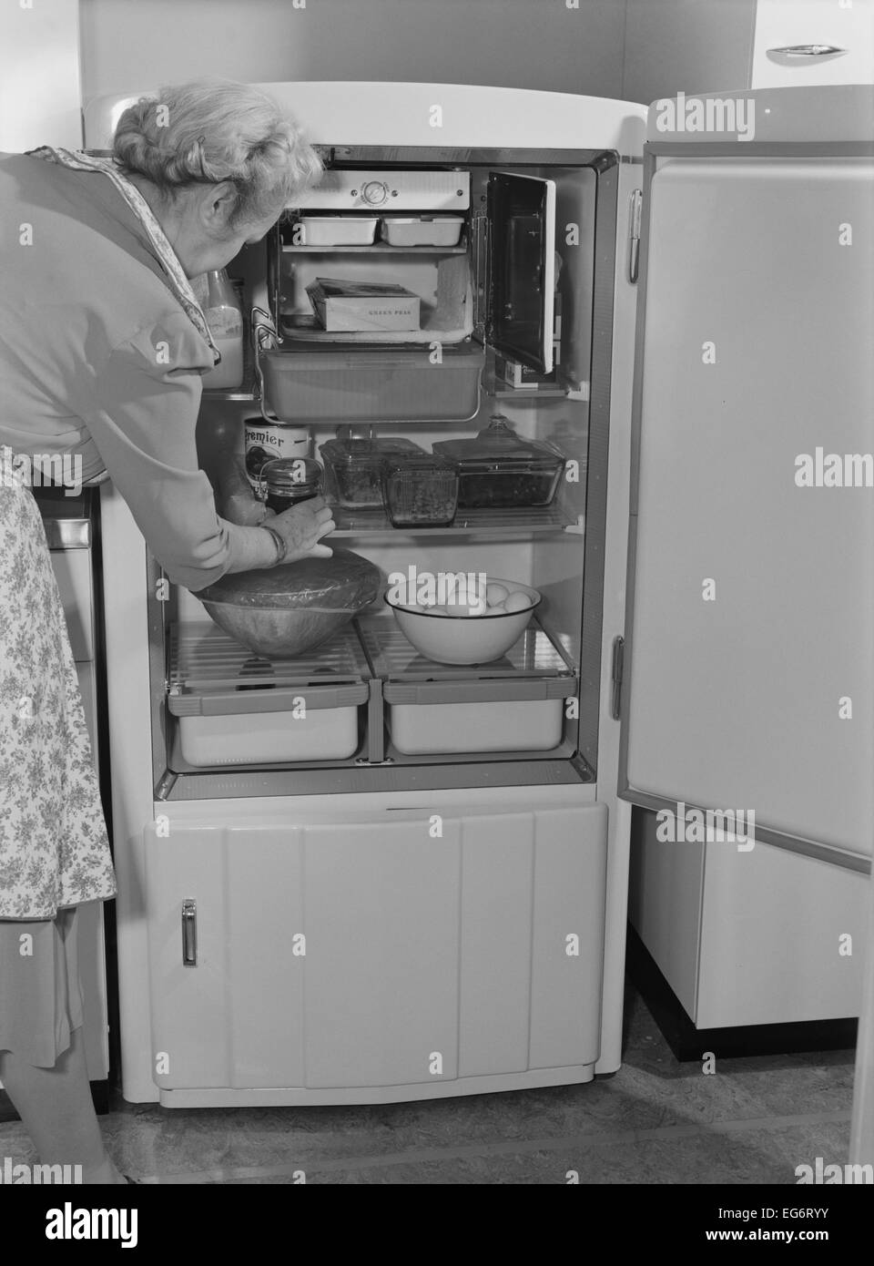 Interior of a 1940's refrigerator has a small freezer section. The most perishable foods were stored near the freezer. The Stock Photo