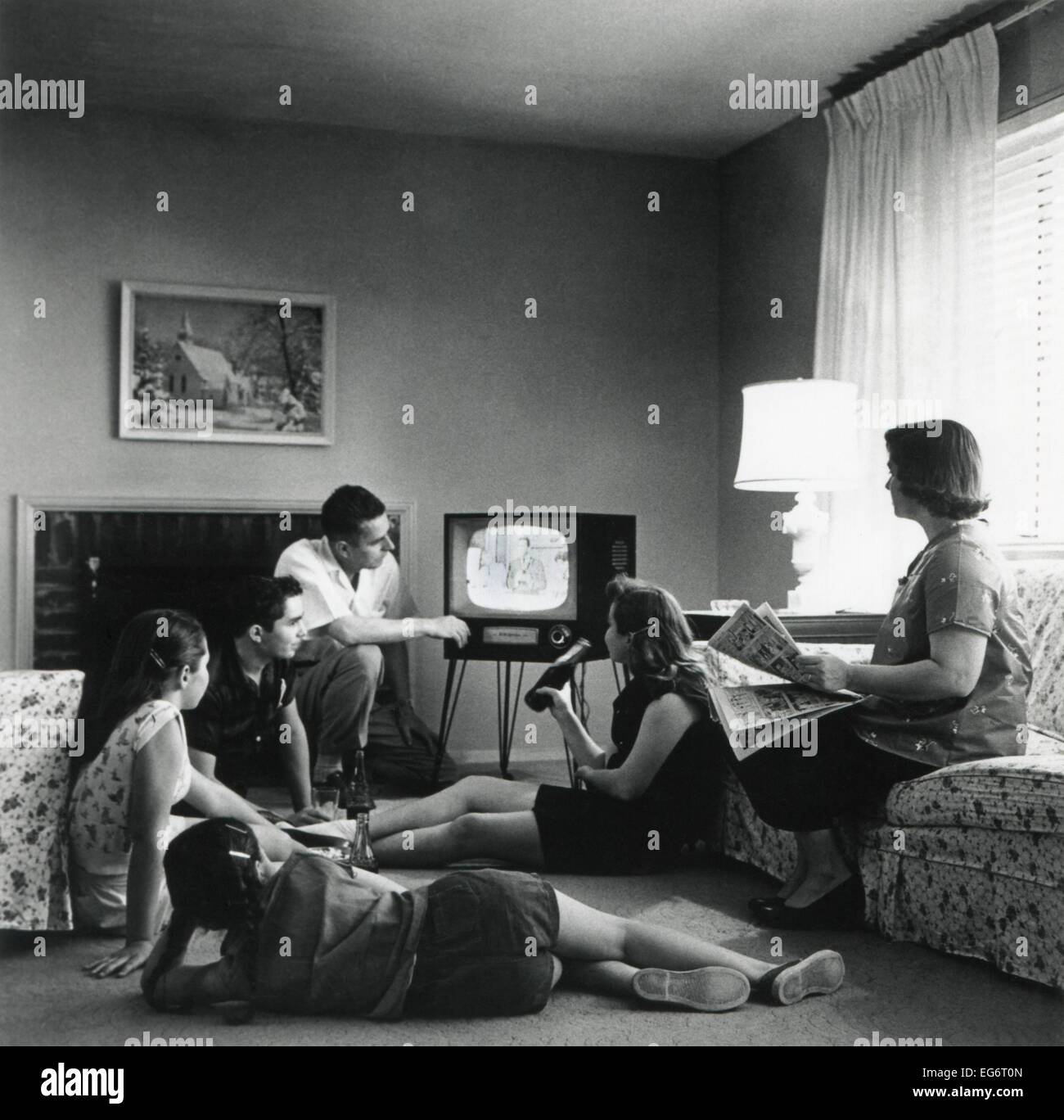 American family viewing television in the living room of their home. 1959. (BSLOC 2014 13 163) Stock Photo