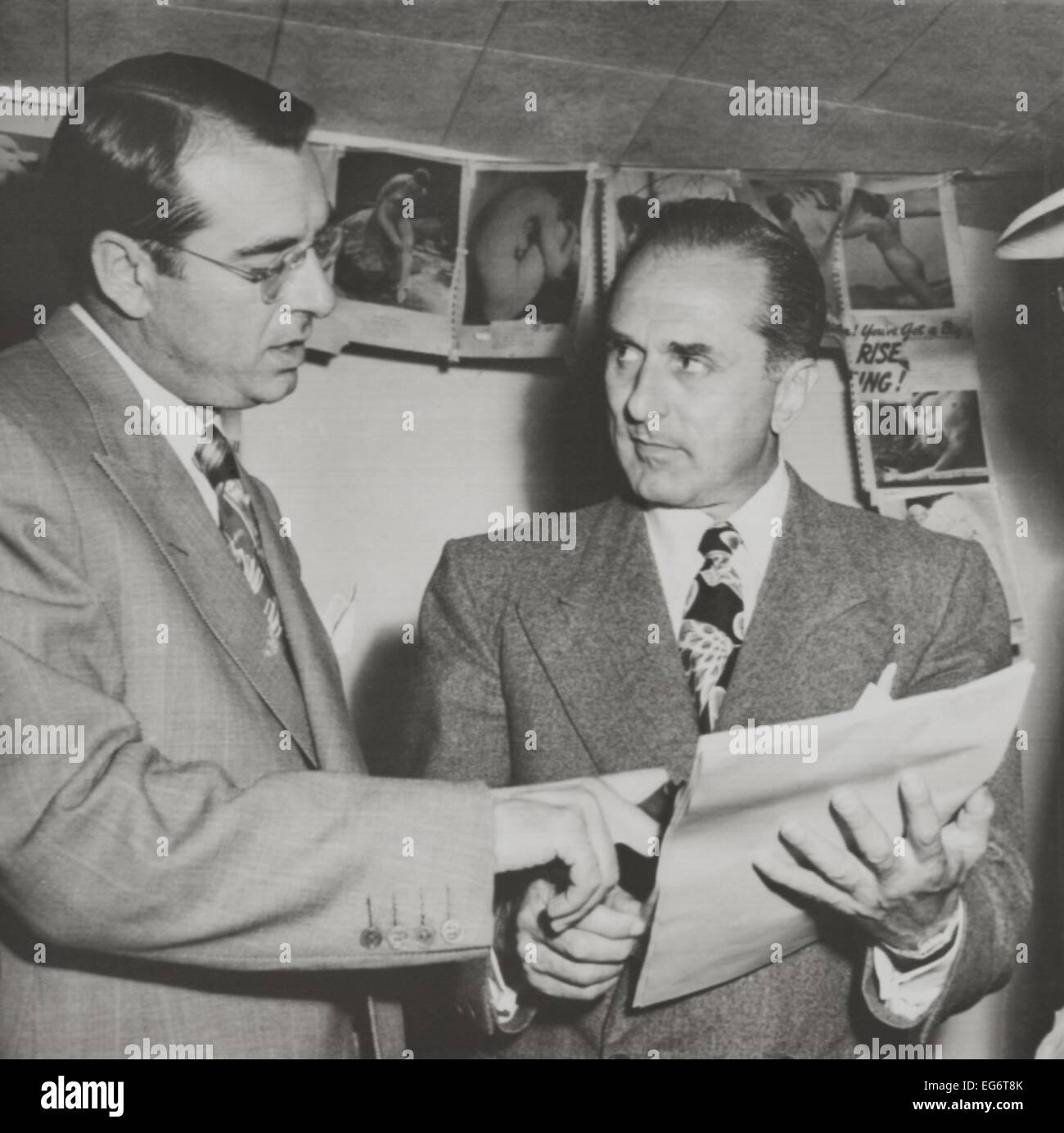 Gangster Johnny Rosselli (right) checks a writ of habeas corpus with his lawyer, Frank Desimone. On July 28, 1948 Rosselli Stock Photo