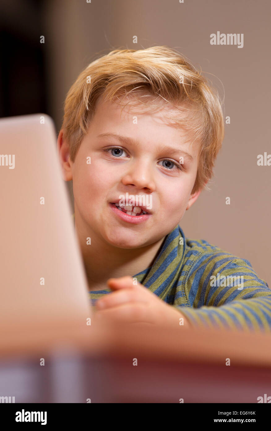 Young male child working on a wireless computer at her primary school Stock Photo