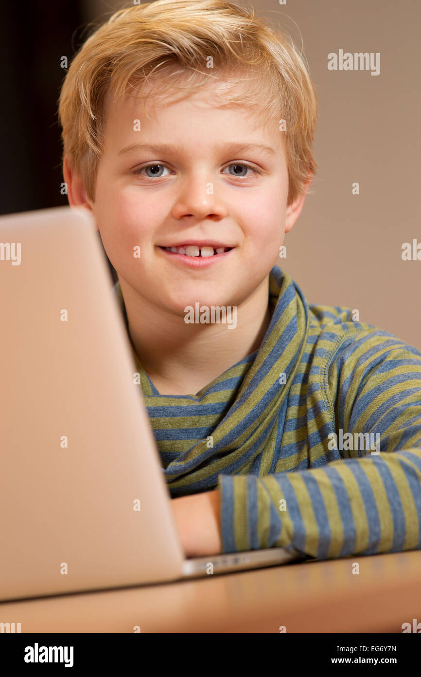 Young male child working on a wireless computer at his primary school Stock Photo