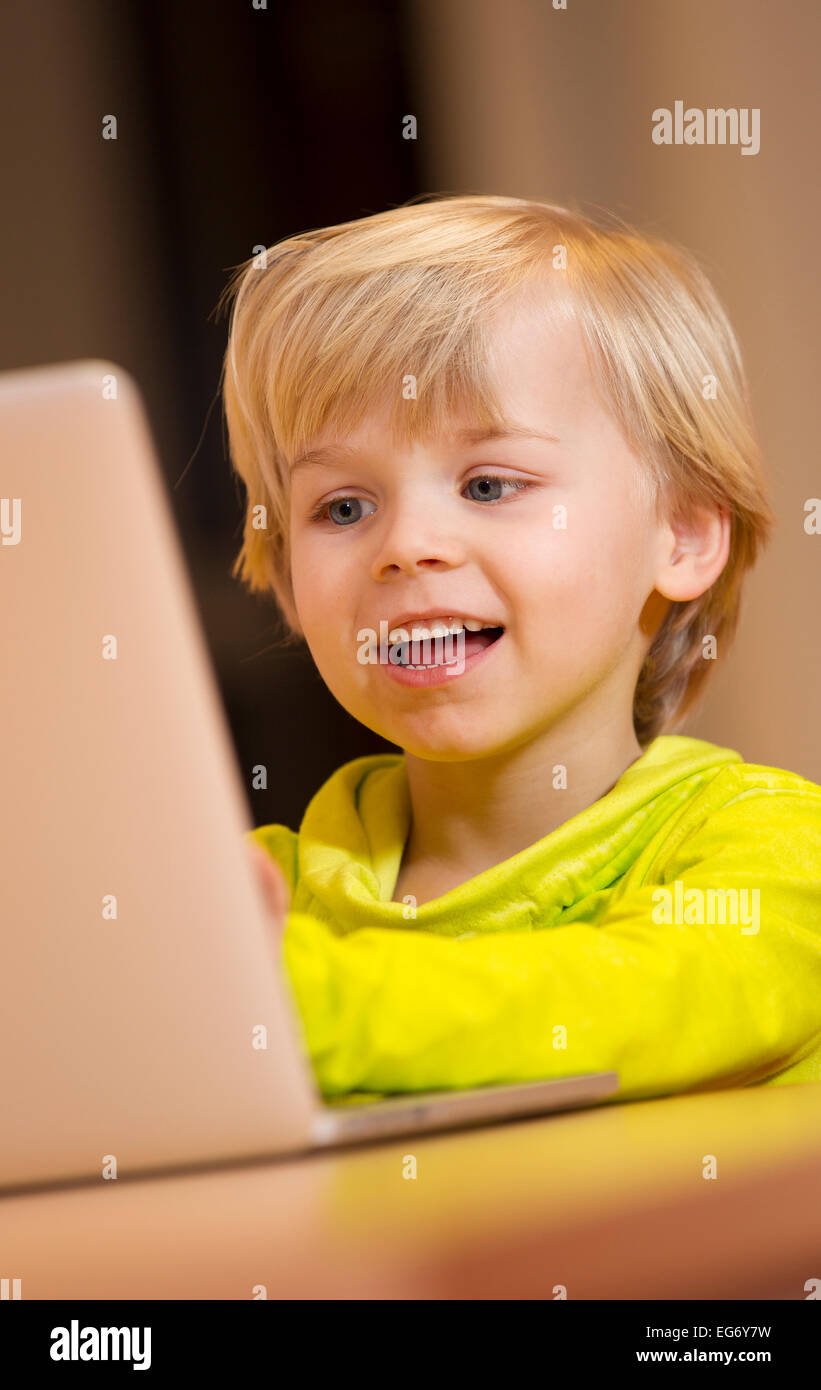 Young male child working on a wireless computer at her primary school Stock Photo