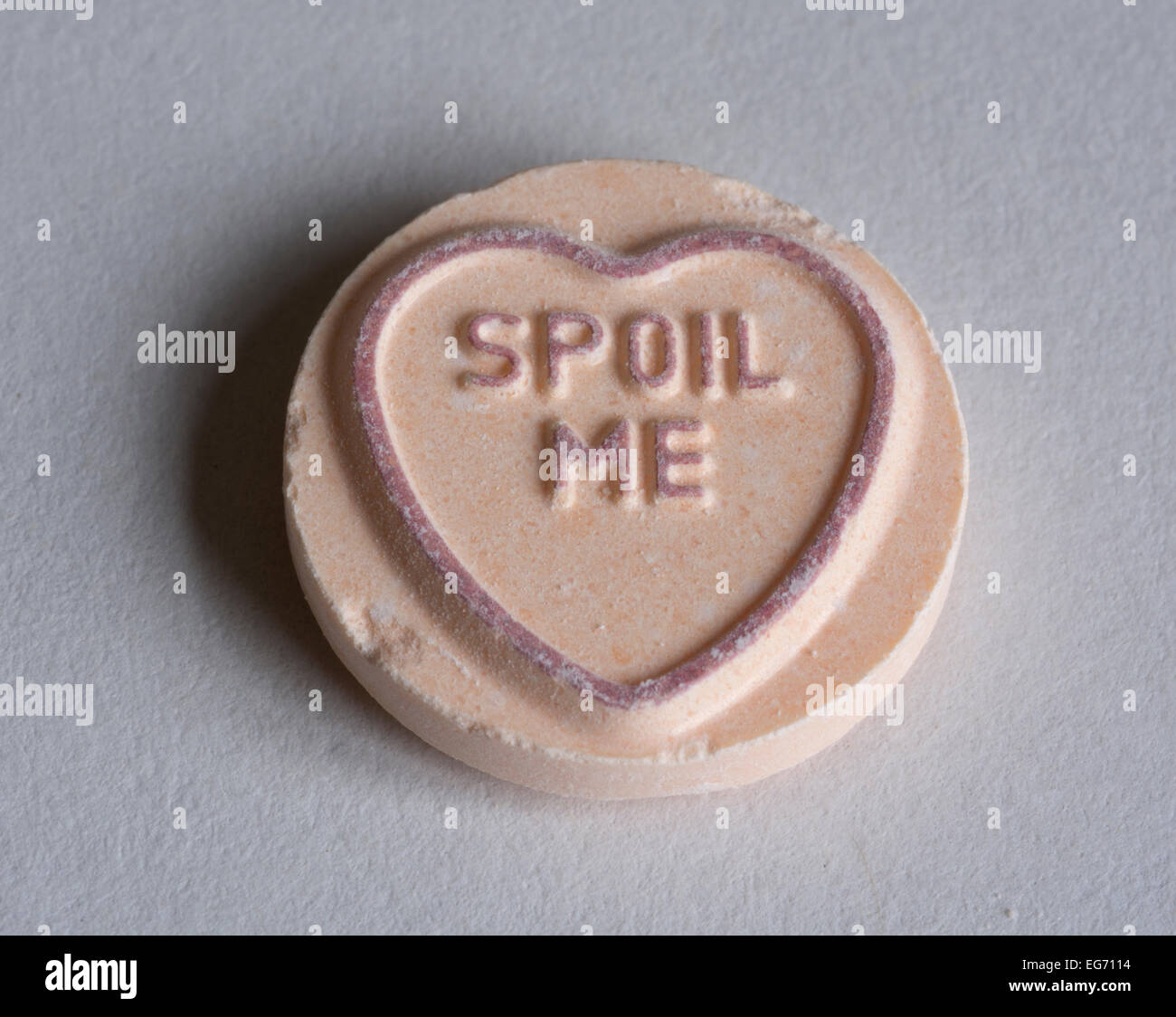 A Love Hearts sweet with the message "Spoil me". Stock Photo