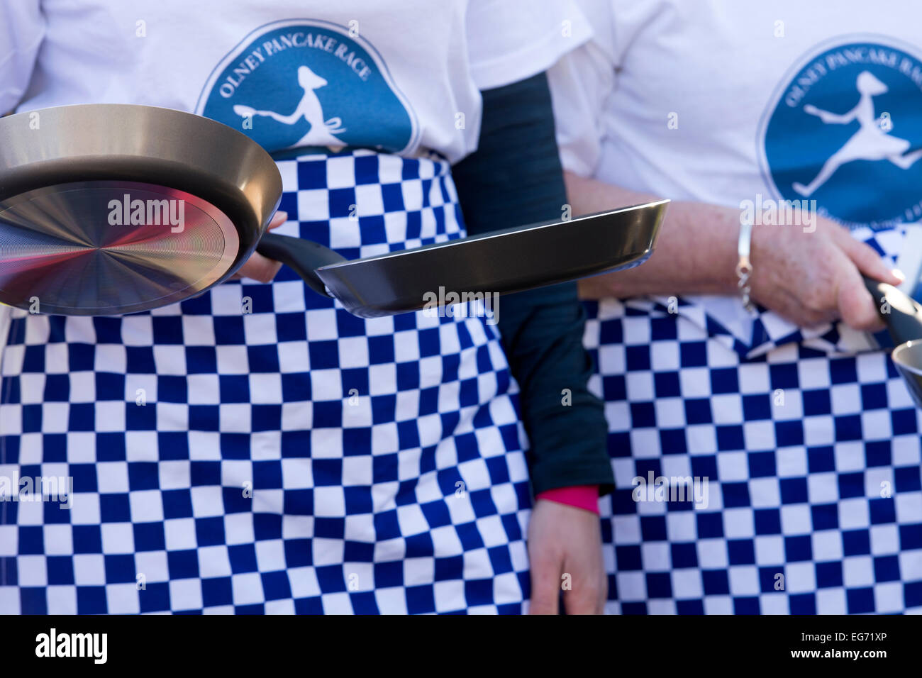 Pancake race women with frying pans, Olney, Buckinghamshire, England, UK Stock Photo