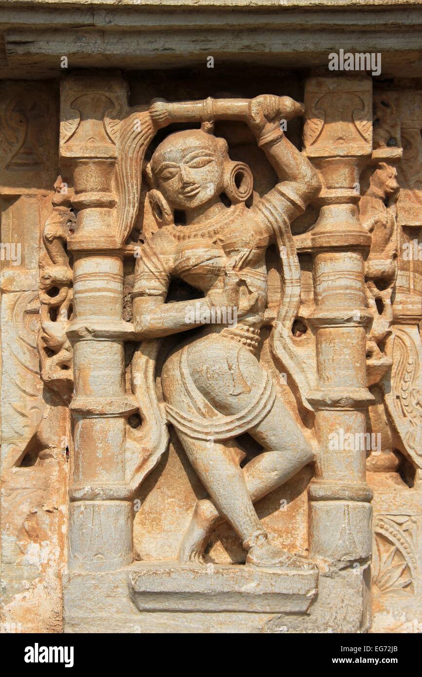 Nicely poised sculpture of maid servant on wall pane at Vijay Sthambh (Victory Tower), Chittorgarh Fort, Rajasthan, India, Asia Stock Photo