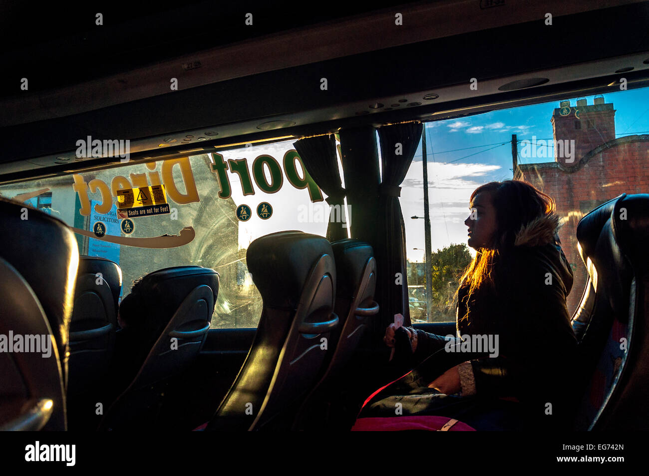 Woman backlit on a Bus Eireann coach in Ireland Stock Photo