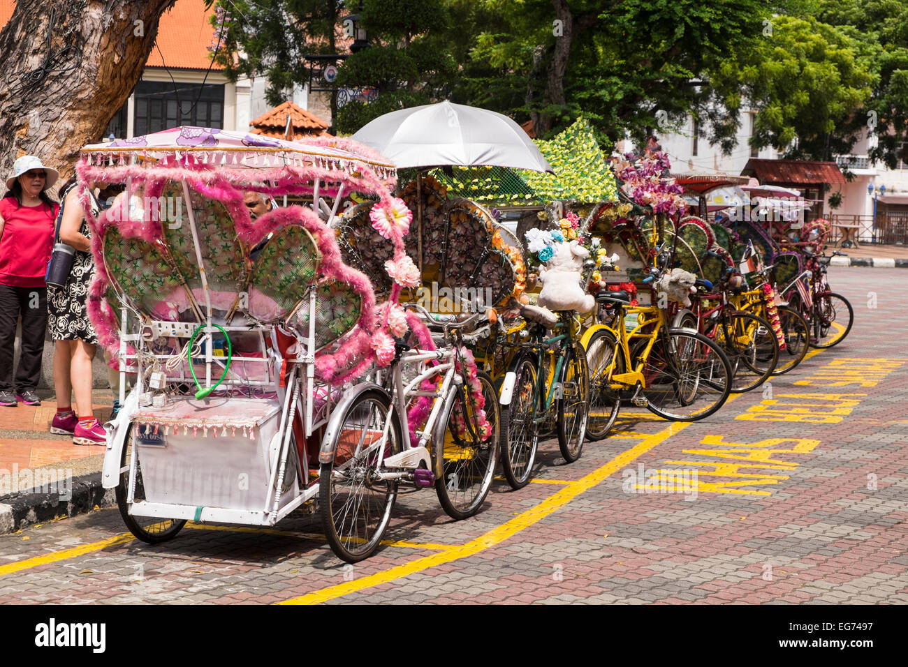 Melaka's famous colourful trishaws take tourists on leisurely rides around the old town. Malaysia. Stock Photo