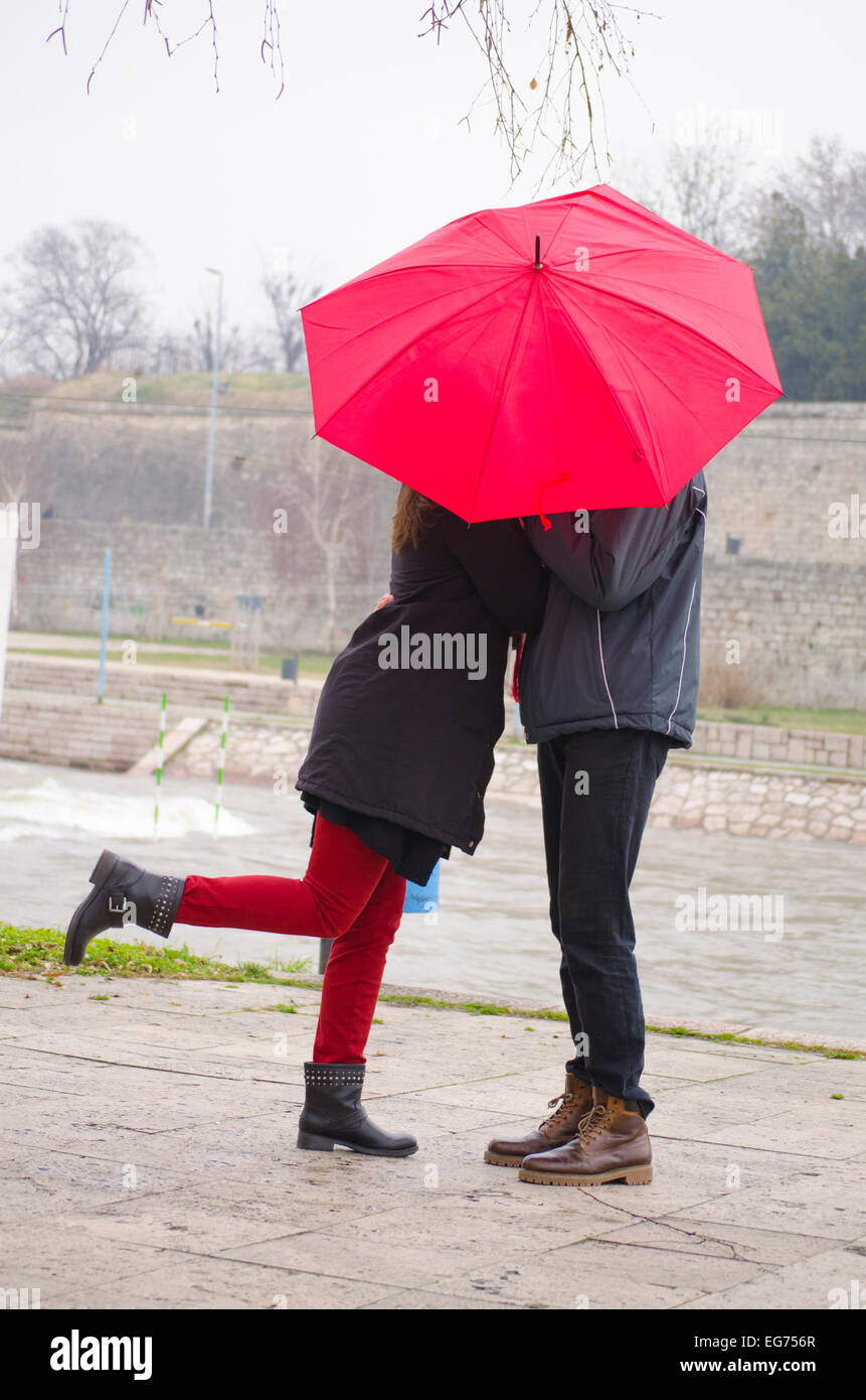 Couple kissing behind umbrella hires stock photography and images Alamy
