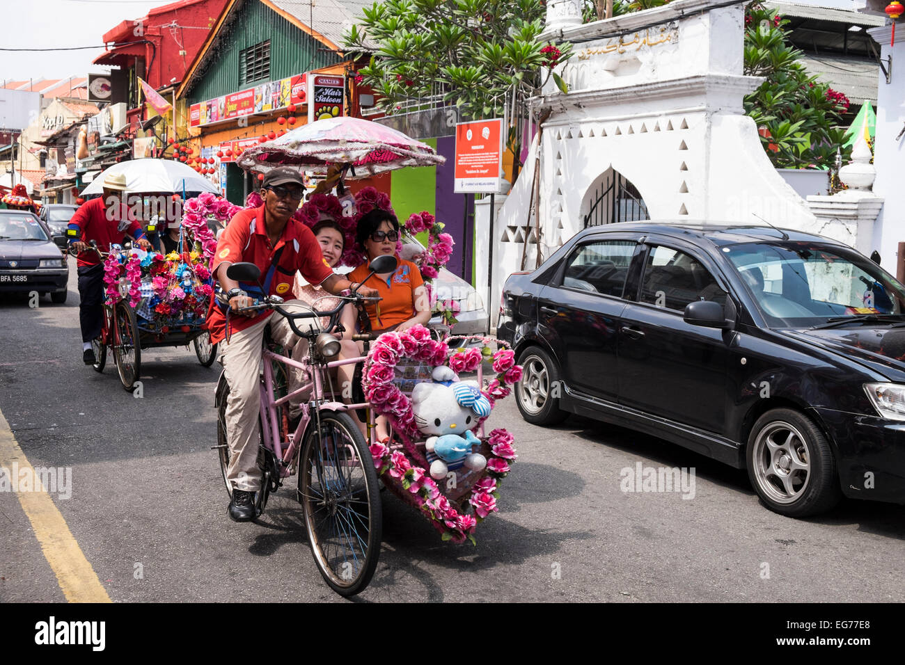 Melaka's famous colourful trishaws take tourists on leisurely rides around the old town. Malaysia. Stock Photo