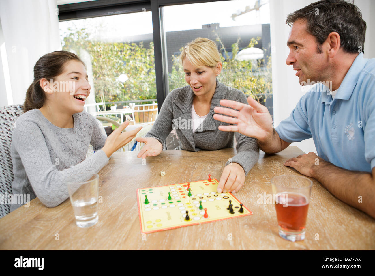 Family playing ludo at home Stock Photo