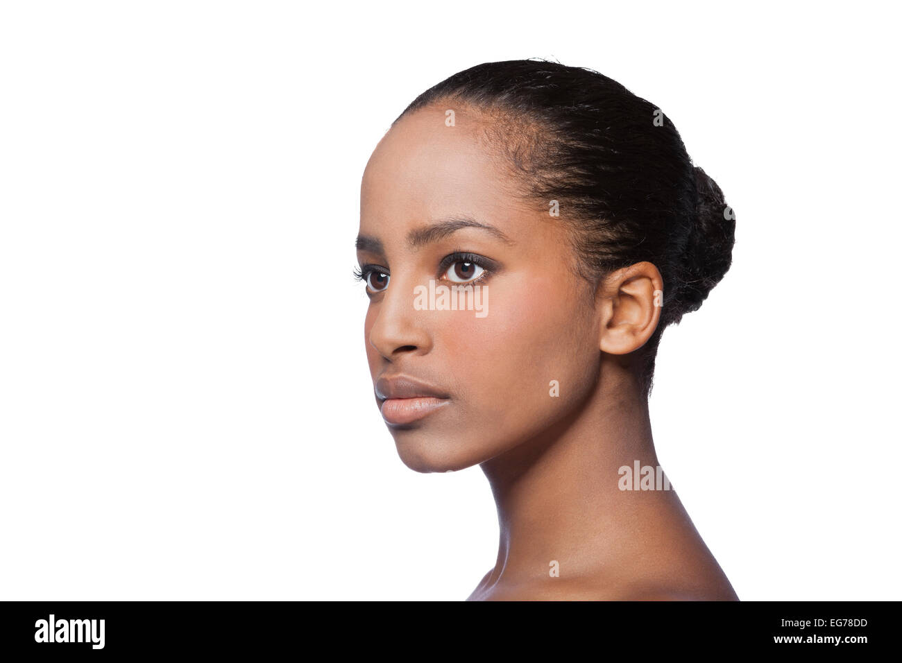 Portrait of serious looking young woman in front of white background Stock Photo