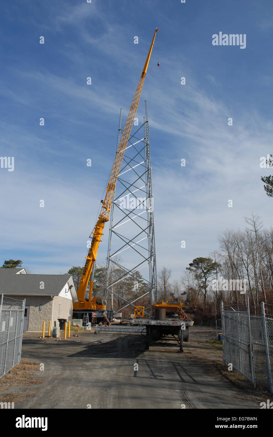 A Crane being used to construct a Cellphone Tower. Stock Photo