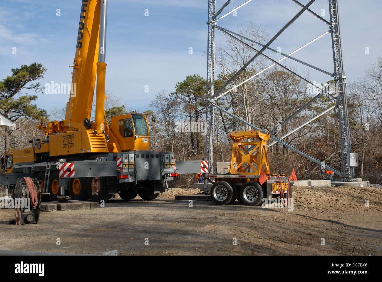 A Crane being used to construct a Cellphone Tower. Stock Photo