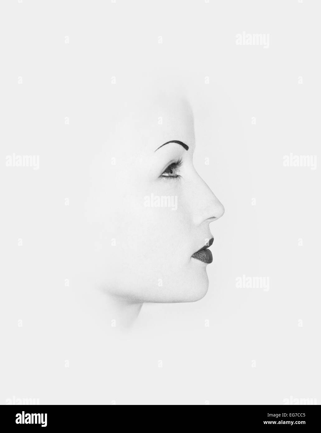 A cut out of a young 'goth' or gothic woman's profile against white background Stock Photo