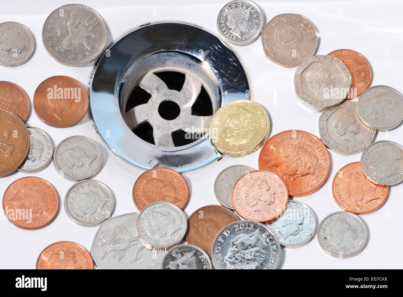 Wasted money going down the drain Stock Photo