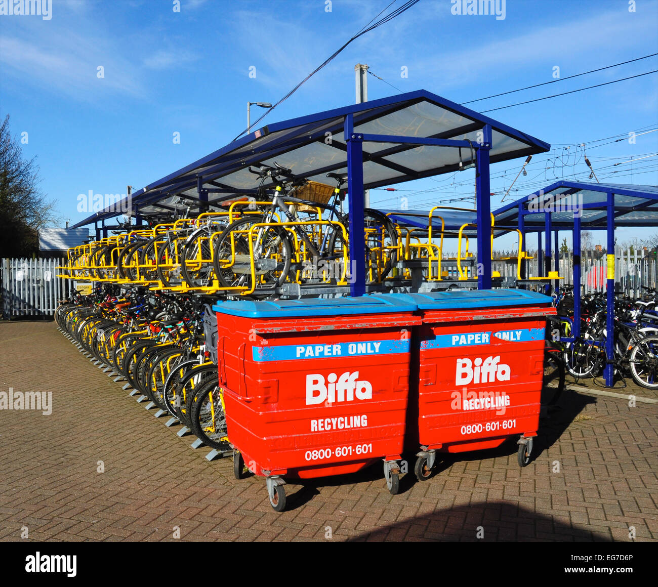 Cycle racks and recycling bins, Hitchin Railway Station, Hertfordshire, England, UK. Stock Photo