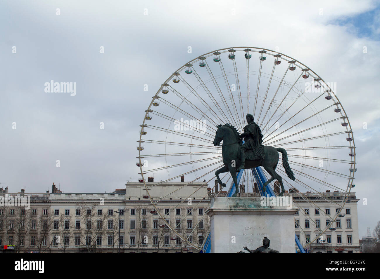 Equestian statue of Louis XIV in Bellecourt, Lyon,France with the panoramic ferris wheel in the background. Stock Photo