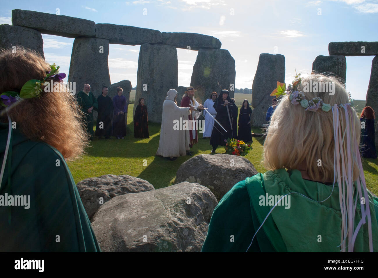 Druid Festival at Stonehenge flowers in hair and swardbearers - Stock Image