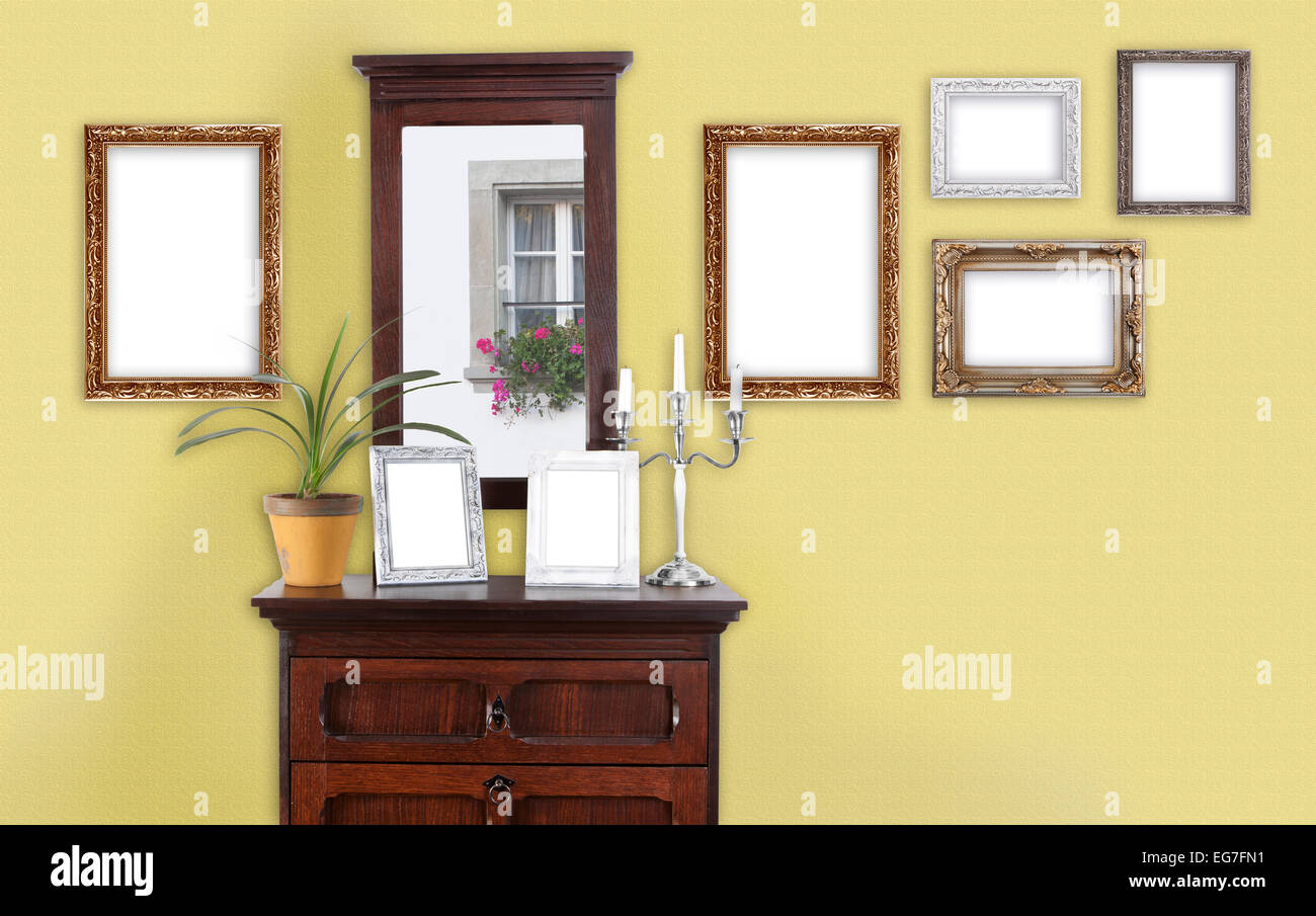 on a wall with a dresser hang several picture frames Stock Photo