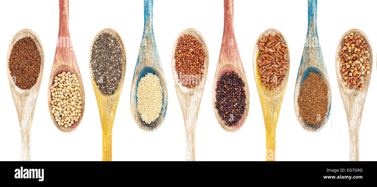 a collection of gluten free grains and seeds on isolated wooden spoons