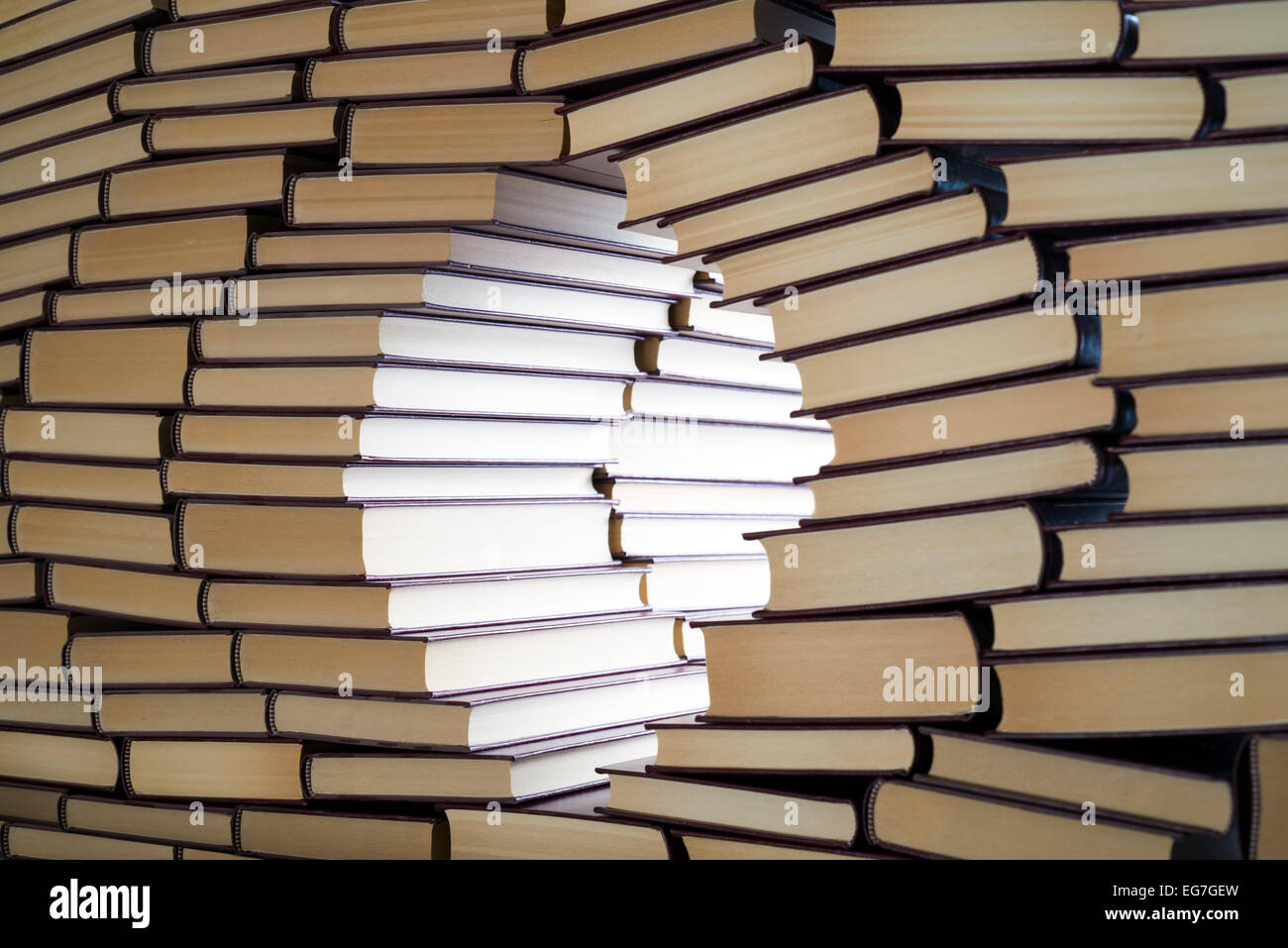 an open window in a wall of books Stock Photo