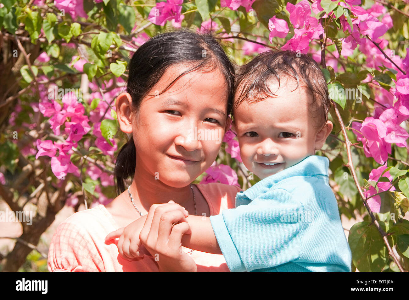 Young girl with small child on the arm, Phu Quoc, Vietnam, Asia Stock Photo
