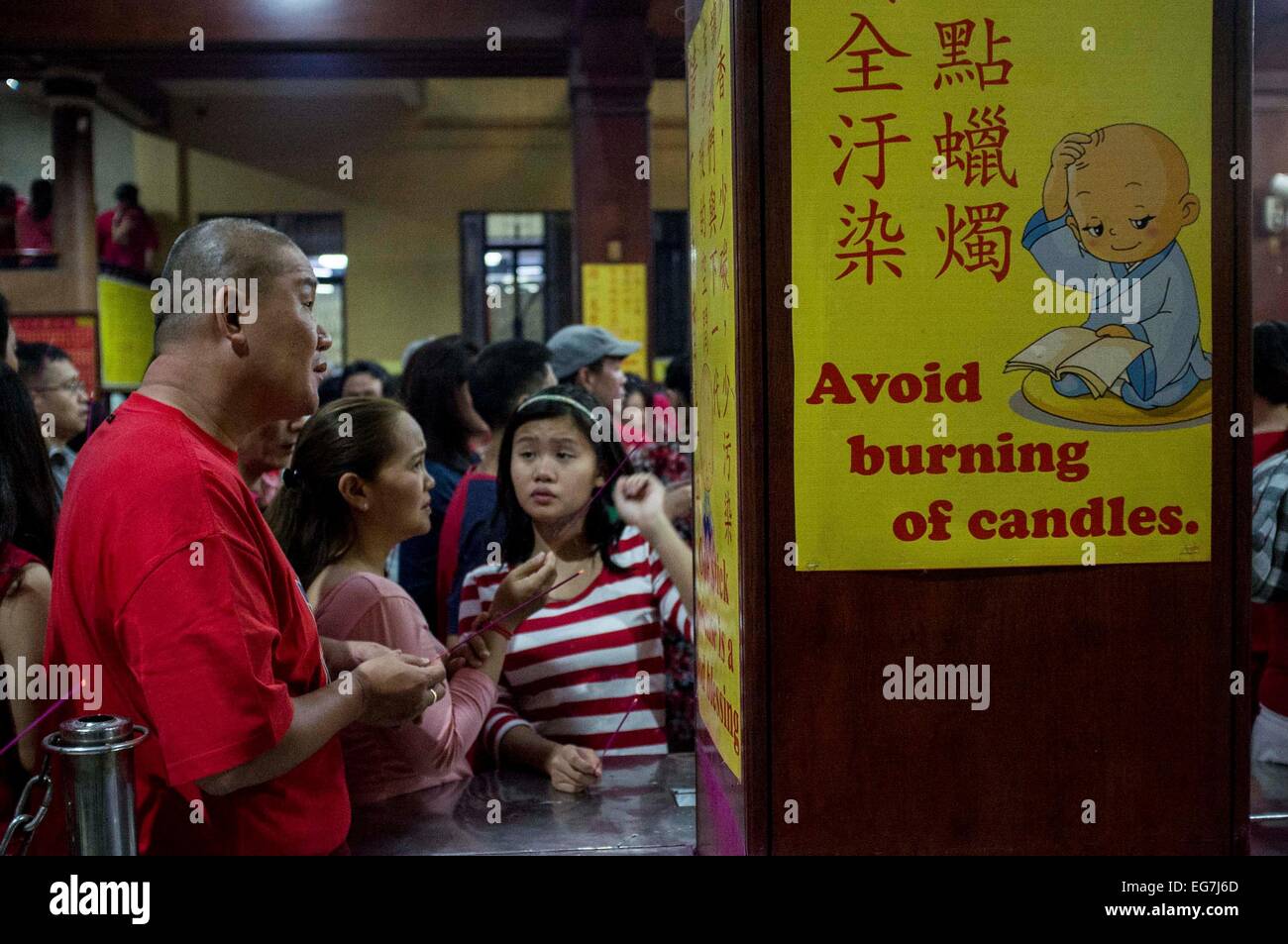 Reminders about burning of candles are posted on the walls of Seng Guan temple to guide the shrine goers. (Photo by Mark Z. Saludes / Pacific Press) Stock Photo