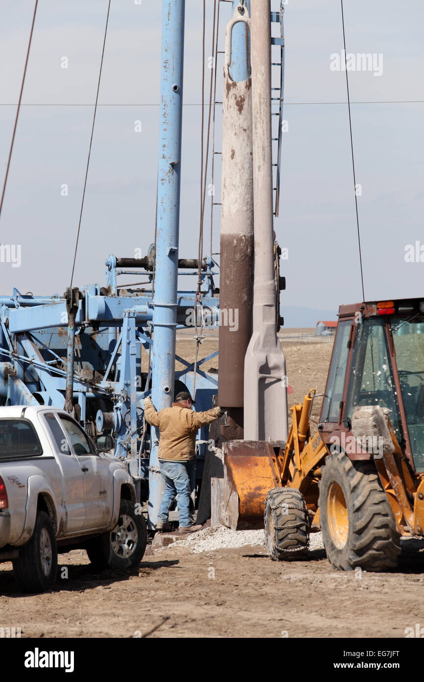 A man working a drilling rig for a water well. Stock Photo