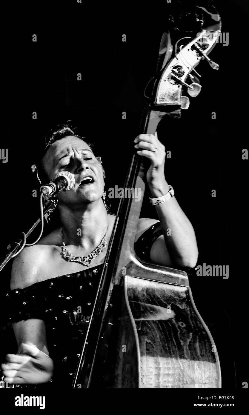 Female double bass player in black and white at Goodwood Revival. Vintage classic period dress attire. Music entertainment. Monochrome Stock Photo