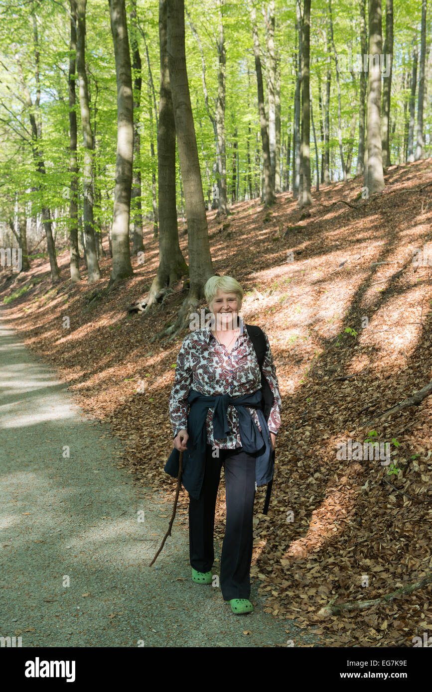 Old woman walking forest hi-res stock photography and images - Alamy